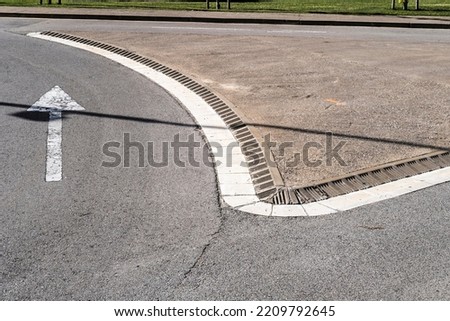 traffic direction sign arrows on an empty street