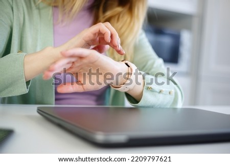Woman using smart watch. Female person browsing notifications on smart watches