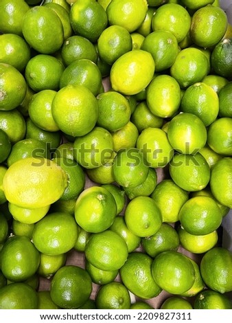 Lemons. Green lemons. Pail of green lemons. lemons ready for sale