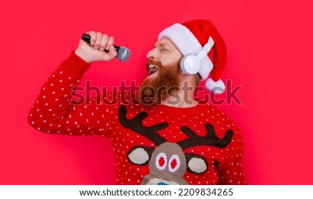 christmas karaoke music. cheerful man singing christmas music in karaoke. christmas santa man