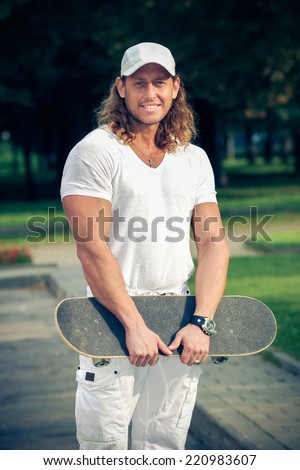 fashionable guy with skateboard