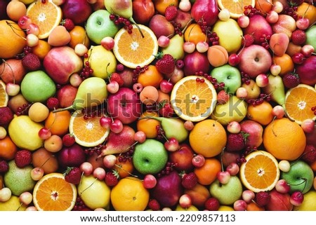 Fresh ripe organic fruits from market: pear and orange, cherry and lemon, apricot and berries, apple and banana