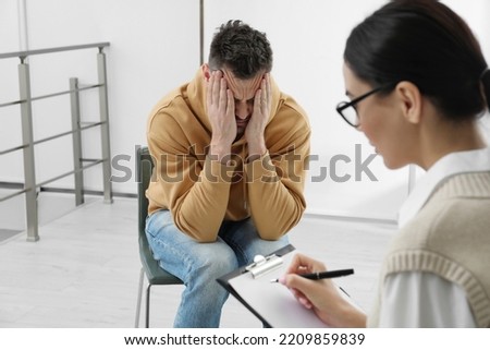 Psychotherapist working with drug addicted man indoors Royalty-Free Stock Photo #2209859839