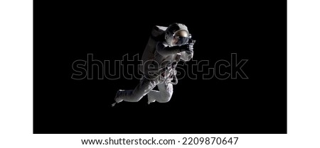 Caucasian female astronaut using her mobile phone during spacewalk, messaging, taking pictures Royalty-Free Stock Photo #2209870647