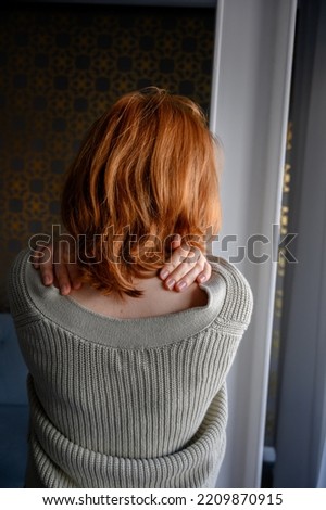 Vertical rear view shot of a beautiful woman's red hair