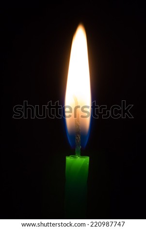 Green candle isolated on black