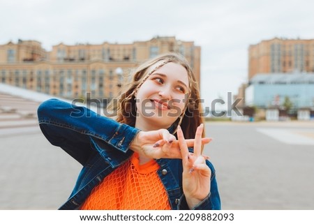 The hashtag of the gesture symbol "Hands show gesture" is viral, web, social networks, network. a young woman shows a hashtag gesture on the street.