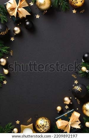 Luxury Christmas poster party invitation card design. Flat lay elegant Xmas decorations, golden balls, gift boxes on black background. Top view, copy space.