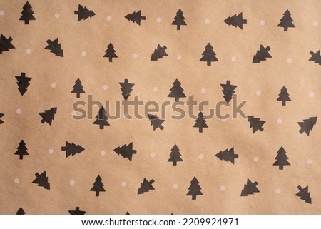 Wrapping paper for gifts with a winter print. Brown recycled paper texture background. Textured paper background. Kraft paper texture.  Royalty-Free Stock Photo #2209924971
