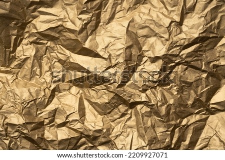 Gold paper texture background. Abstract texture background of wrinkled golden paper. Crumpled foil texture background. Old gold. Matte texture. Abstract background