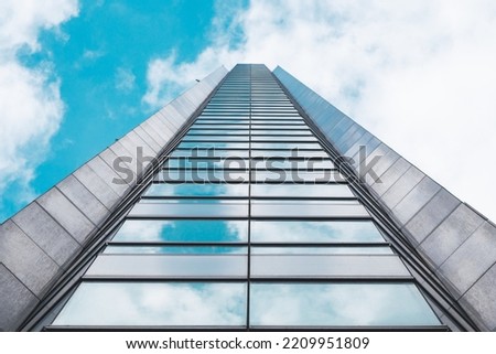 underside panoramic and perspective view to steel blue glass high rise building skyscrapers, business concept of successful industrial architecture Royalty-Free Stock Photo #2209951809