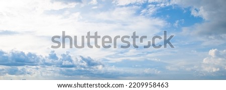 Blue sky and beautiful cumulus clouds. Wide photo.