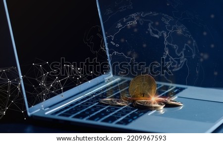 Laptop and Digital money Bitcoin coin Put together. Concept of digital money is becoming a competitor in major currencies such as the dollar. Bitcoin gold coin and defocused chart background. 