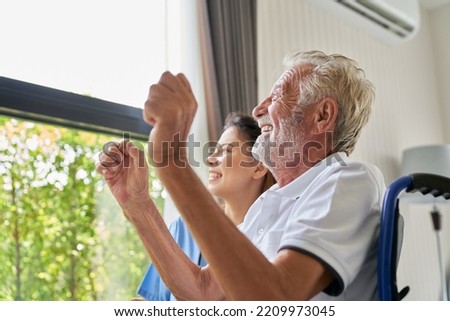 Happy face of oldy patient sitting on wheelchair with smiling nurse , home healthcare service concept. Royalty-Free Stock Photo #2209973045