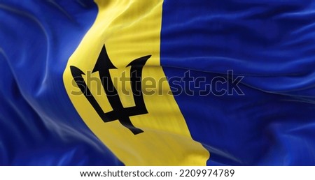 Close-up view of the Barbados national flag waving in the wind. Barbados is an island country in the Lesser Antilles of the West Indies. Fabric textured background. Selective focus