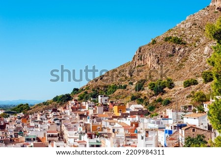 Beautiful landscape with a view on a part of town under the hill on a clear sky background