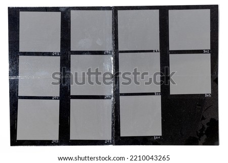 folded shiny black and white handcopy contactsheet paper with blank film frames on white background.
