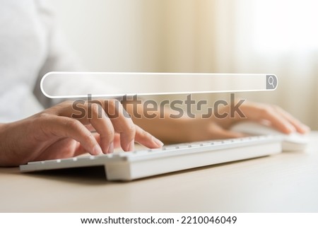Woman searching internet browser for data and information online network. Concept of data research using laptop computer with icon of searching browser. Internet browser on woman used online network.