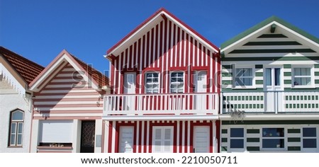Great color striped traditional portuguese Houses with blue sky background 
