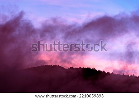 Mountain silhouette at dawn sky with scattered clouds, cold morning in Guatemala, Central America.