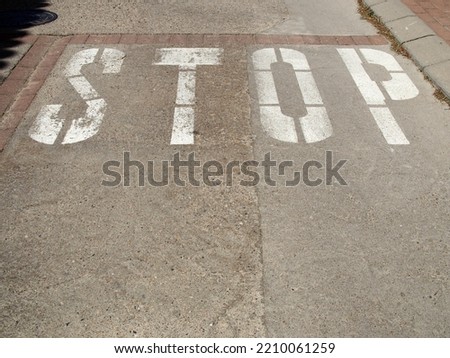 Stop sign painted on the road.