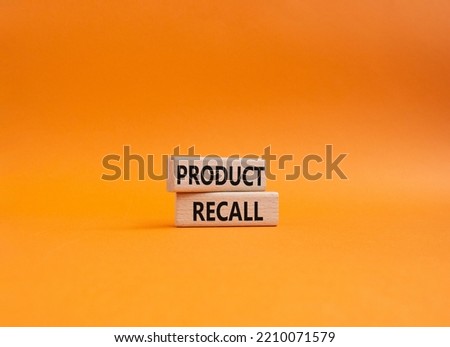 Product recall symbol. Concept words Product recall on wooden blocks. Beautiful orange background. Business and Product recall concept. Copy space.