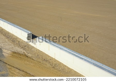 prepared base and concrete border for installation of inflatable playing arena, football hall