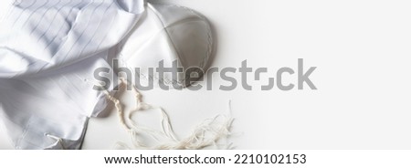 Banner design with prayer shawl tallit and kippah (religious hat). Jewish national tallith katan - in the form of a cape with brushes. Still Life of Jewish symbols for Sukkot, shabbat, rosh hashanah Royalty-Free Stock Photo #2210102153