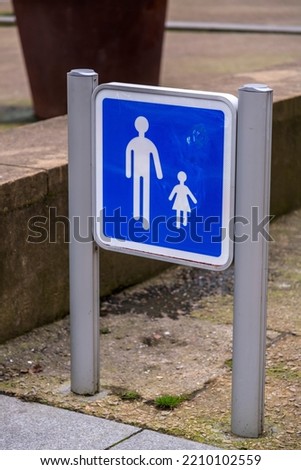 Child and parent pedestrian walking zone signage. Blue and white traffic sign