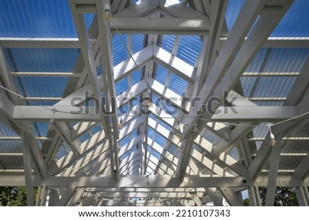 Canopy made of polycarbonate with a wooden structure roof.