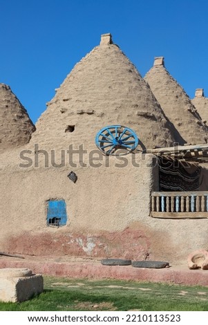 Traditional conical houses of Harran, Sanli Urfa, Turkey. Traditional mud brick buildings topped with domed roofs and constructed from mud and salvaged brick.