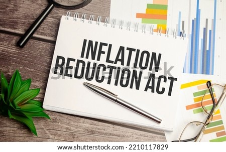 notepad ,chart and calculator. Top view text INFLATION REDUCTION ACT Royalty-Free Stock Photo #2210117829