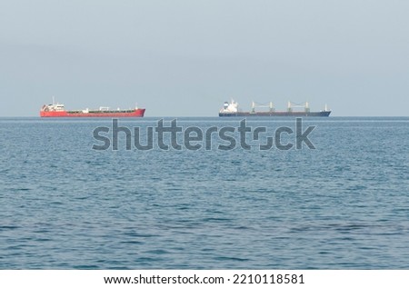 A view of cargo ships moving far across the sea. Sea transport.