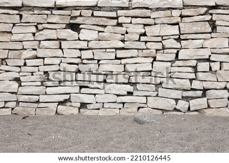 Texture of a stone wall background. Part of a stone fortress or castle fencing for background