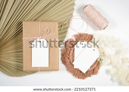 Scandinavian Boho Theme Product Mockup. Blank gift tags flatlay styled with bohemian theme dried palm frond leaf and natural materials against a white background.
