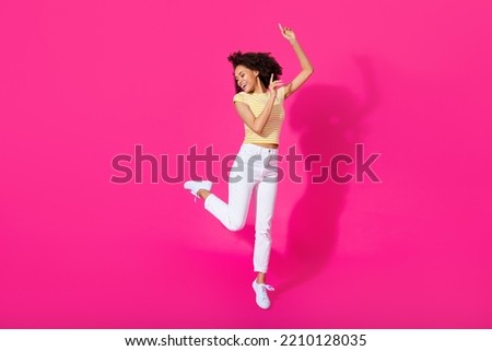 Ful size photo of lovely young lady dance bachelorette party dressed stylish yellow striped outfit isolated on bright pink color background