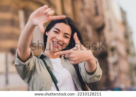 Photo of cute sweet lady dressed green shirt showing fingers photo shot enjoying fall sunny weather outdoors urban town street