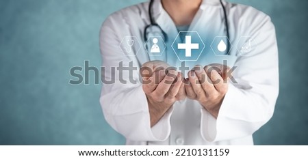 Doctor holding virtual medical icons in hand