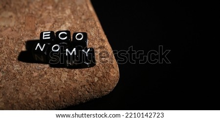 Economy word of plastic cube concept on wooden background.