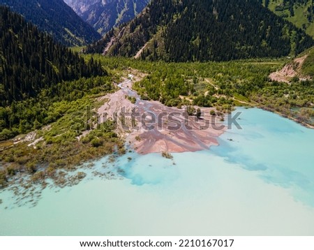 Summer landscape of the alpine lake Issyk near the city of Almaty. Beautiful view of the lake in the mountains. Royalty-Free Stock Photo #2210167017