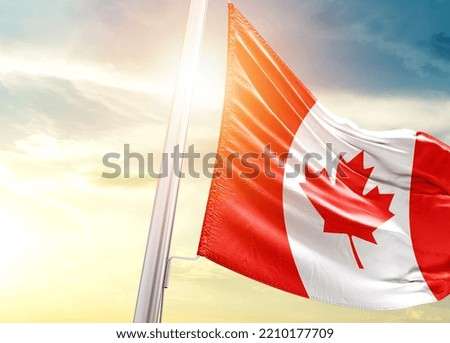 Canada national flag cloth fabric waving on the sky with beautiful sunlight - Image