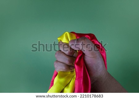 Red and yellow flag. Hand holding bicolor flag. pride and patriotism. freedom of a nation, revolution and democracy