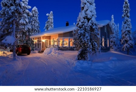 A summer cottage in the morning twilight in the middle of the snow Royalty-Free Stock Photo #2210186927