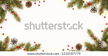   Spruce, fir branches, red berries on white background. Frame border. Christmas composition. Space for text.                                