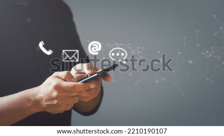 Businessman using smartphone with the email, call phone, address, Chat message icons. Customer support hotline Contact us people connection. 