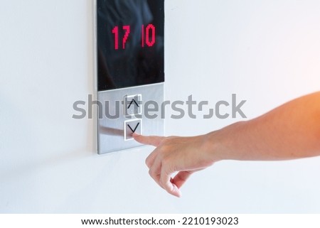 Hand finger press the Elevator button, woman waiting for Elevator in office or apartment