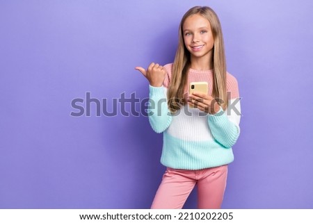 Photo of positive girl hand show empty space recommend cool offer proposition device gadget shop isolated on purple color background