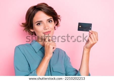 Photo of young pretty adorable nice cute positive minded girl touch chin thoughtful about buy new clothes hold credit card isolated on pink color background