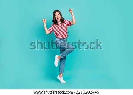 Full body size photo of young gorgeous nice pretty woman wear stylish outfit fists up celebrate career up isolated on aquamarine color background
