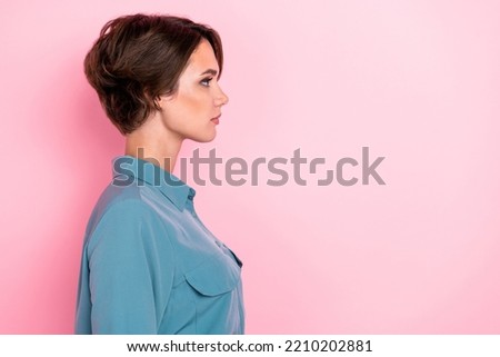 Profile photo portrait of winsome young lady look empty space focused manager wear stylish blue garment isolated on pink color background